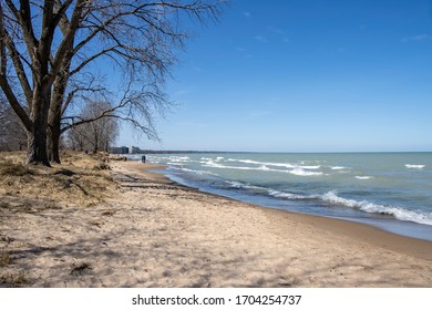 A Family Walks Along A Lake Michigan Beach In Wilmette, Illinois With Other People Nearby While Attempting To Social Distance During The Coronavirus Pandemic Of 2020.