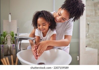 Family, washing hands and child with mom rinsing, cleaning and good hygiene against bacteria or germs for infection or virus protection in bathroom. Girl kid with woman for health and cleanliness - Shutterstock ID 2207159589