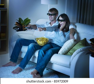 Family Watching 3D Film On TV