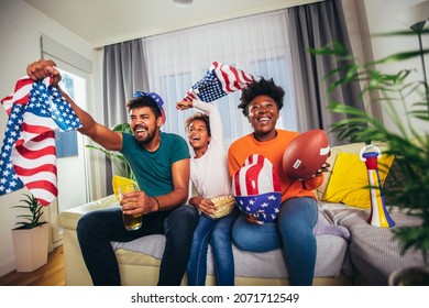 Family Watching American Football Match On Television At Home