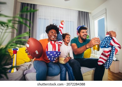 Family Watching American Football Match On Television At Home