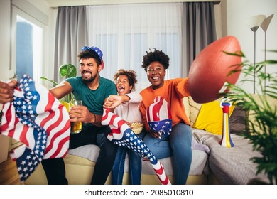 Family Watching American Football Match On Television At Home