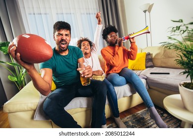 Family Watching American Football Match On Television At Home