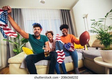 Family Watching American Football Match On Television At Home