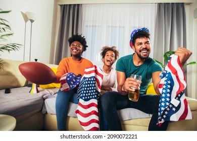 Family Watching American Football Match On Television At Home