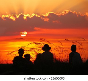 Family Watching A Beautiful Sunset