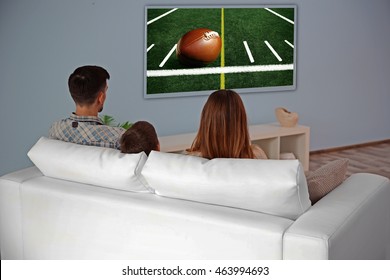 Family Watching Football Game On Tv At Home.