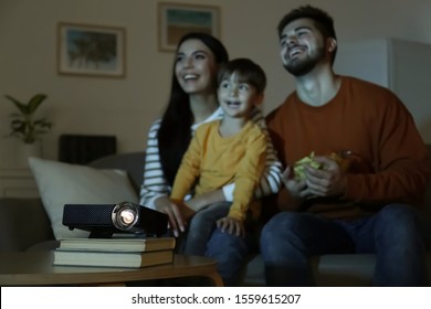 Family Watching Movie At Home, Focus On Video Projector