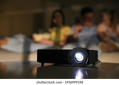 Family Watching Movie At Night, Focus On Video Projector