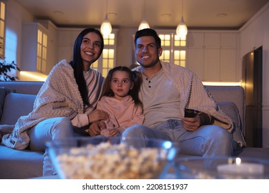 Family Watching Movie On Sofa At Night