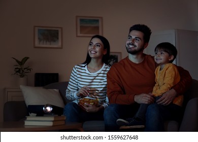 Family Watching Movie Using Video Projector At Home