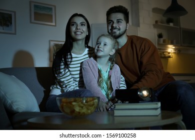 Family Watching Movie Using Video Projector At Home