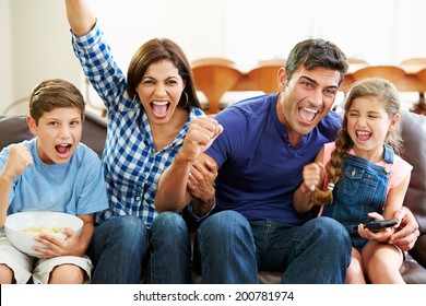 Family Watching Soccer Celebrating Goal