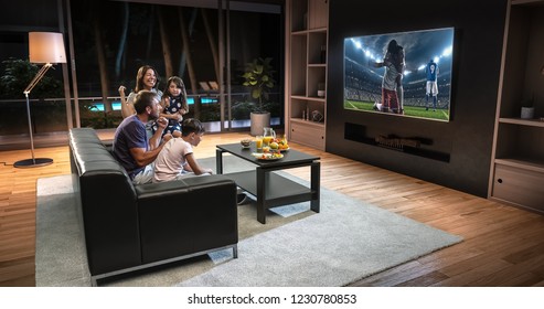 A family is watching a soccer moment on the TV and celebrating a goal, sitting on the couch in the living room. The living room is made in 3D. - Shutterstock ID 1230780853