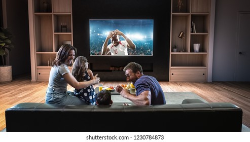 A family is watching a soccer moment on the TV and celebrating a goal, sitting on the couch in the living room. The living room is made in 3D. - Shutterstock ID 1230784873