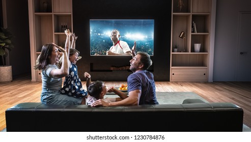 A family is watching a soccer moment on the TV and celebrating a goal, sitting on the couch in the living room. The living room is made in 3D. - Shutterstock ID 1230784876