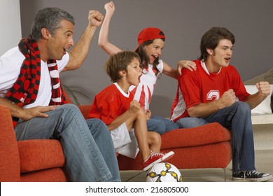 Family Watching A Sports Match On TV.