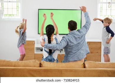 Family Watching Sports On Television And Cheering