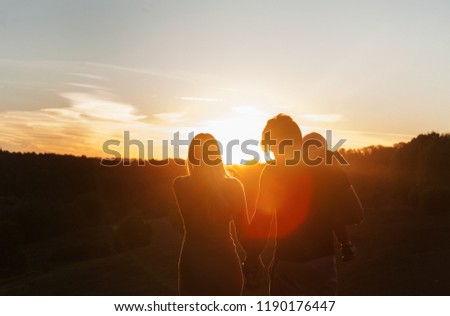 Similar – 2 junge Frauen sitzen auf der Wiese und sehen in die Ferne