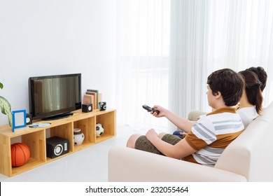 Family Watching Tv At Home