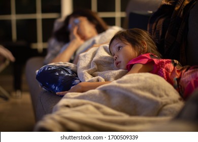 Family Watching Tv At Home Late Night. 