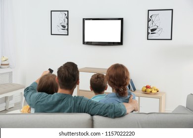 Family watching TV in room at home - Shutterstock ID 1157022220