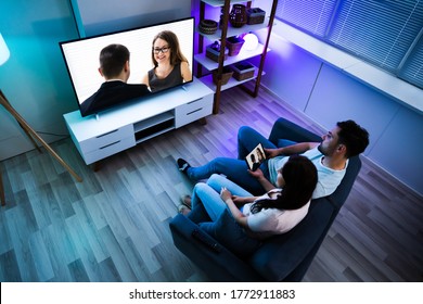 Family Watching TV Through Tablet Television And Movie Streaming 