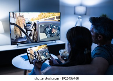 Family Watching TV Through Tablet Television And Movie Streaming