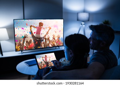 Family Watching TV Through Tablet Television And Movie Streaming - Shutterstock ID 1930281164