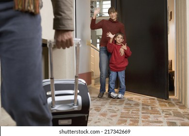 Family Waving Goodbye To Father Leaving For A Trip