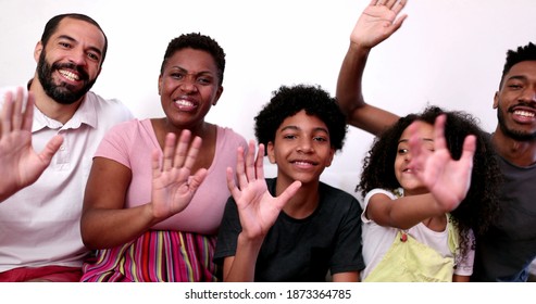 Family Waving Hello To Camera Speaking Video Conference POV