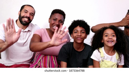 Family Waving Hello To Camera Speaking Video Conference POV