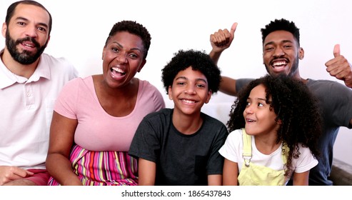 Family Waving Hello Or Goodbye To Camera. Happy Mix Race Parents And Kids