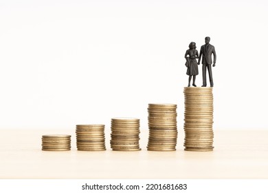 Family Wealth Process Concept. Couple Figurine On Rising Coin Stacks. Copy Space