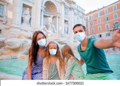 Family Wearing Face Masks At Fontana Di Trevi, Rome, Italy. Coronavirus Flu Virus Travel Concept Banner.