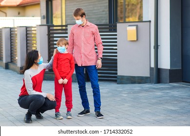 Family Wearing Face Masks Outside Home. Safety Mask To Protect Coronavirus Outbreak. Prevention Coronavirus. Son With Parents Going For A Walk. New Real Life.Fight Coronavirus. Coronavirus Quarantine.