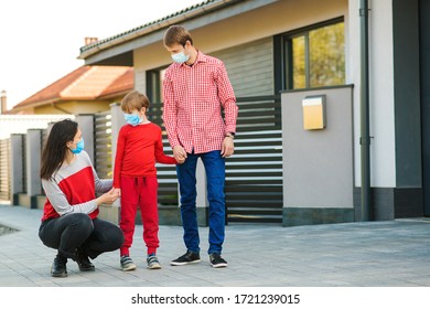 Family Wearing Face Masks Outside Home. Safety Mask To Protect Coronavirus Outbreak.Prevention Coronavirus. Son With Parents Going For A Walk. New Real Life. Fight Coronavirus. Coronavirus Quarantine.