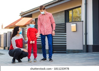 Family Wearing Face Masks Outside Home. Safety Mask To Protect Coronavirus Outbreak. Prevention Coronavirus. Son With Parents Going For A Walk. New Real Life.Fight Coronavirus.Coronavirus Quarantine