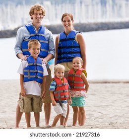 Family Wearing Life Jackets At Beach