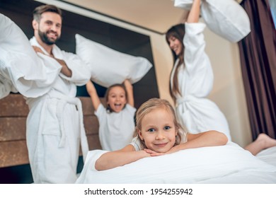 Family In White Robes Having A Pillow Fight