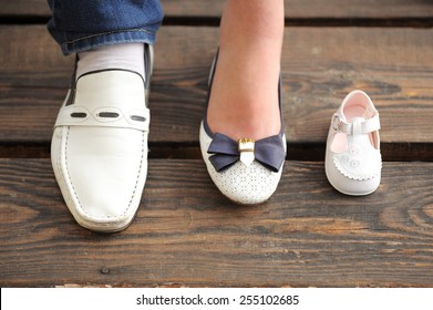 family of white shoes waiting for baby