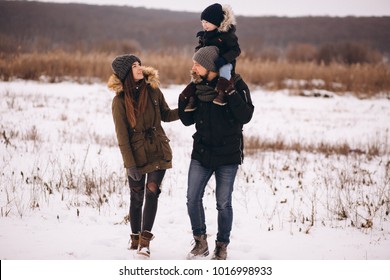 Family In Winter In Forest With Son