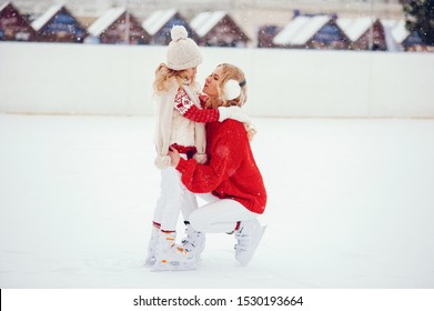 Family In A Winter Park. Mother With Daughter In A Ice Arena