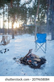 Family Winter Picnic. Bonfire And Camping Chair, Winter Family Walk In Snowy Forest, Outdoor Weekend At Snowing Day, Winter Travel, Vertical Photo