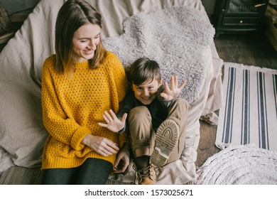 Family Winter Time. Mother And Son Having Fun Indoors