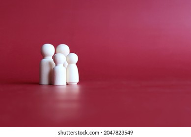 Family wooden dolls on red background with copy space - Powered by Shutterstock