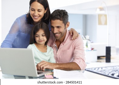 Family Working At Laptop With In Home Office