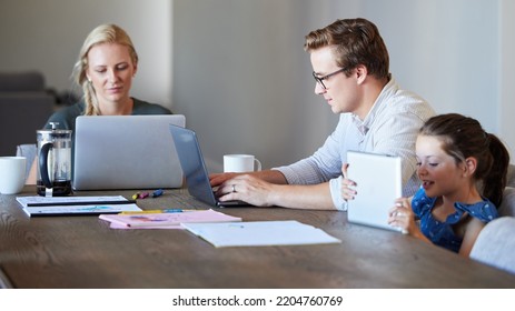 Family Working On Laptop With Child Learning On Digital Tablet In Their Home Dining Room Table. Remote Multimedia Parents With Finance, Schedule Or Time Management While Girl Kid Watch Cartoon Online