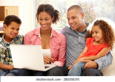 Family Working On Laptop At Home