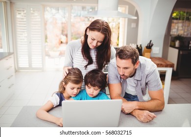 Family Working On Laptop At Home